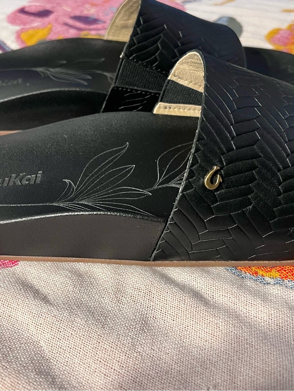OluKai Black Slide Sandals with Woven Upper and Gold Accent
